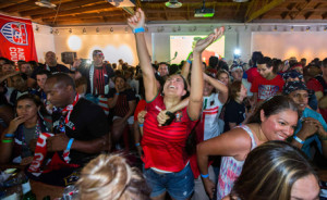 Portugal soccer fan, surrounded by USA fans, cheers for Portugal's second goal during the 2014 World Cup Group G soccer match between Portugal and the U.S. at a viewing party in Los Angeles