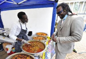 dennis-brown-serves-tv-chef-levi-roots-at-the-caribbean-food-festival-280504543