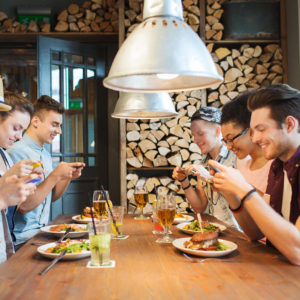 happy friends with smartphones picturing food